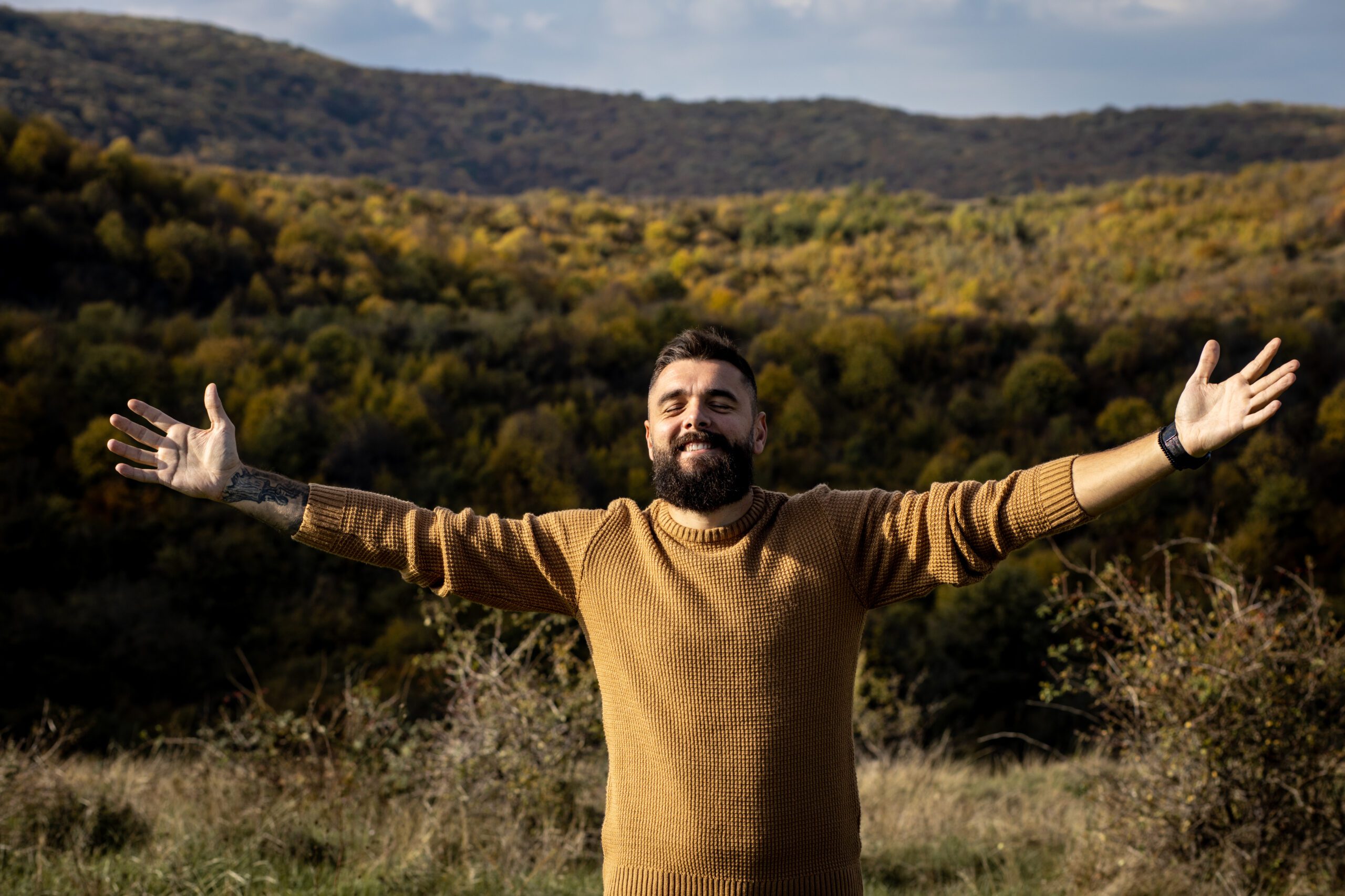 Man enjoying nature with open arms