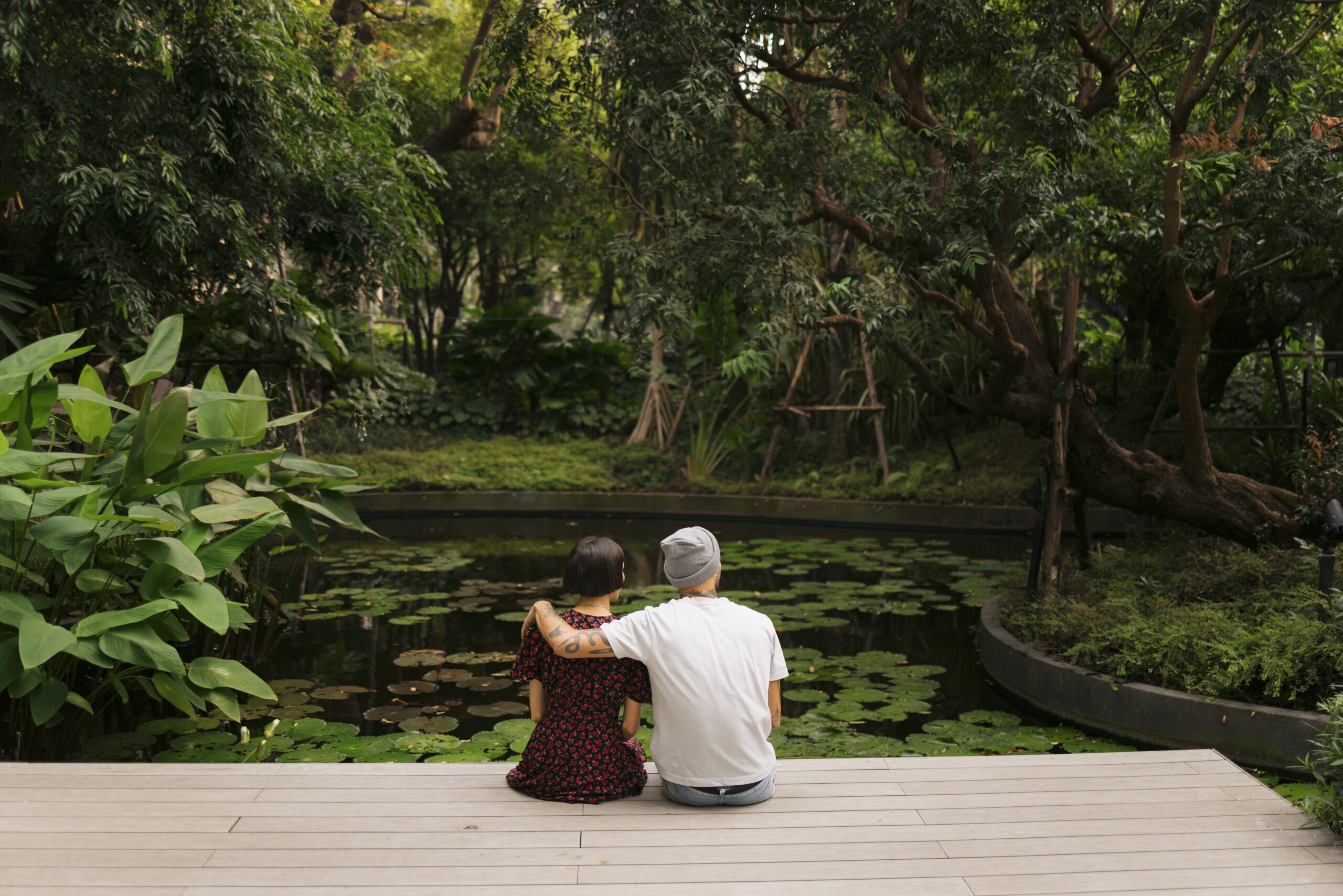 Couple sitting by a serene pond