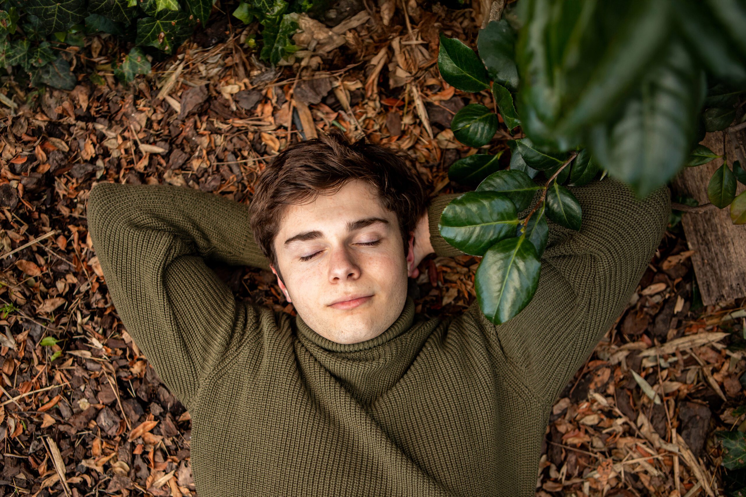 Man relaxing on forest floor