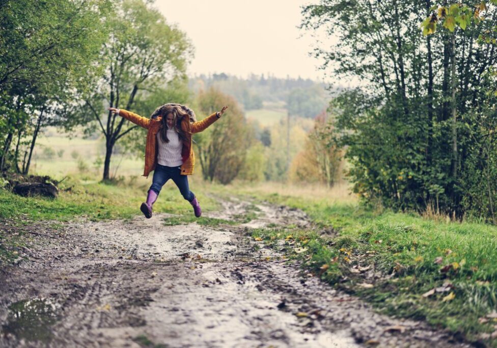 Kid playing outdoors in autumn