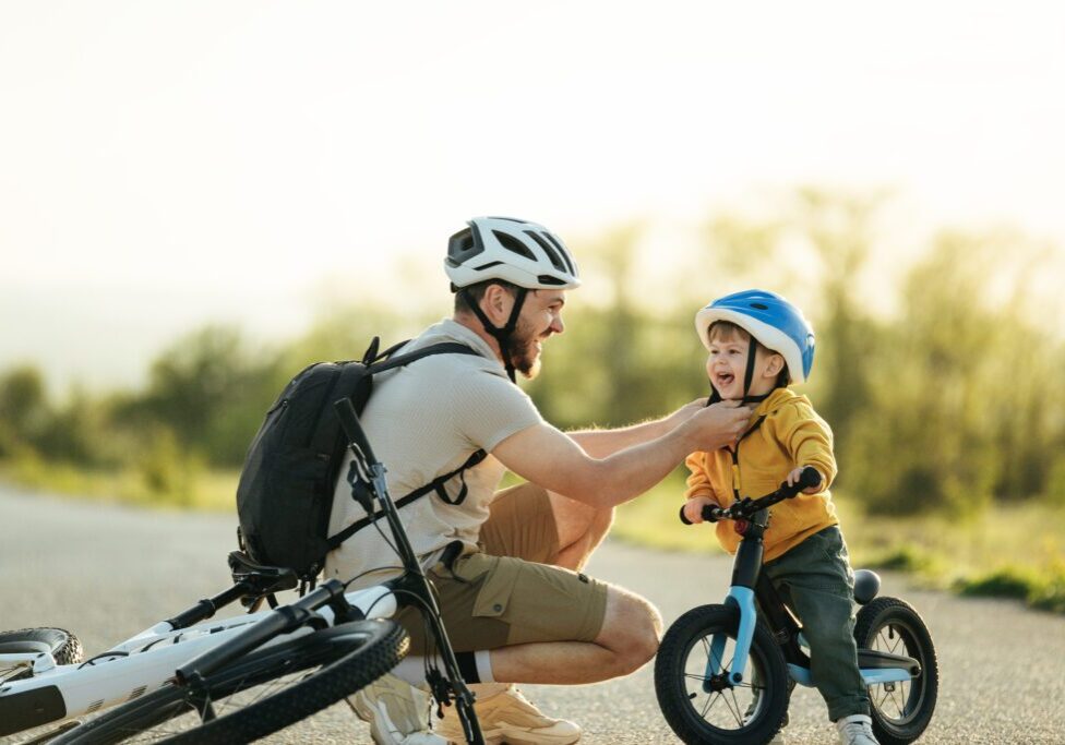 Father and child biking together
