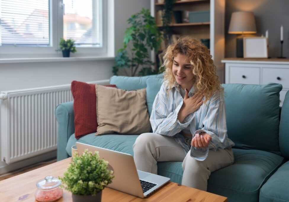 Woman video chatting on laptop at home