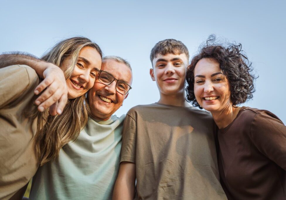Family smiling together outdoors